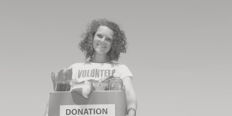 Volunteer carrying food donation box